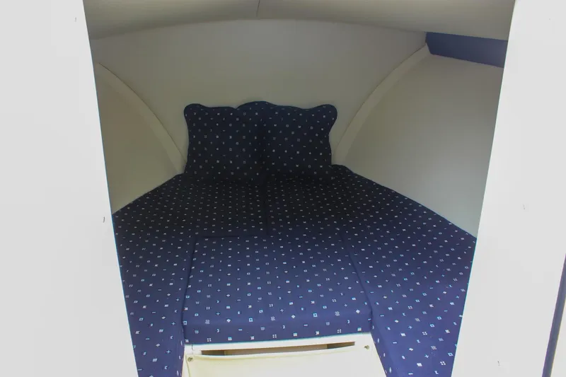 Slide: The Image of 2017 Chris-Craft Capri 27 interior with wooden panel and beige upholstery. - 46