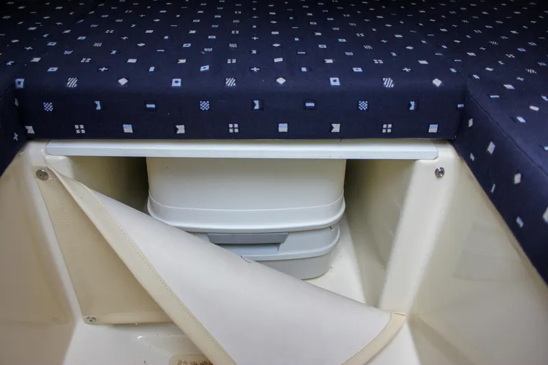 Slide: The Image of 2017 Chris-Craft Capri 27 cabin interior with blue patterned bedding. - 48