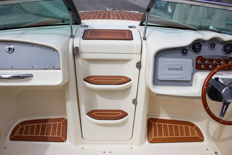 Slide: The Image of 2017 Chris-Craft Capri 27 cabin interior with blue patterned bedding. - 49