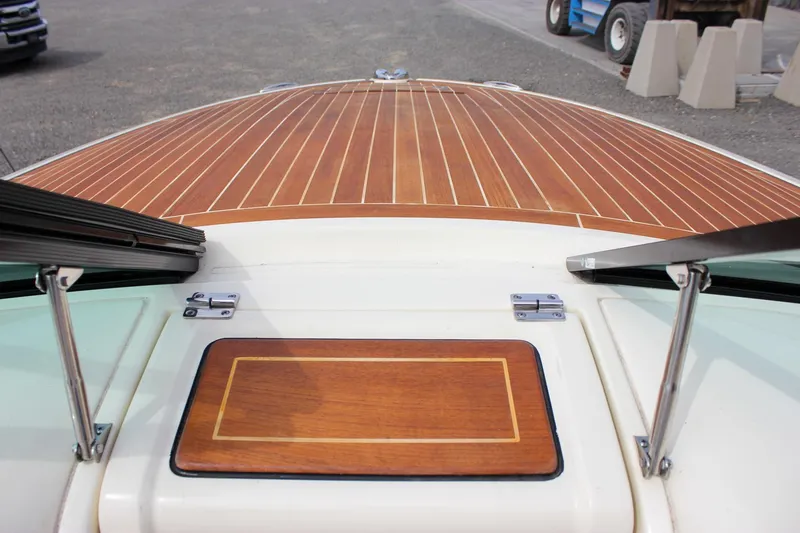 Slide: The Image of 2017 Chris-Craft Capri 27 dashboard with Garmin navigation and classic wood accents. - 51