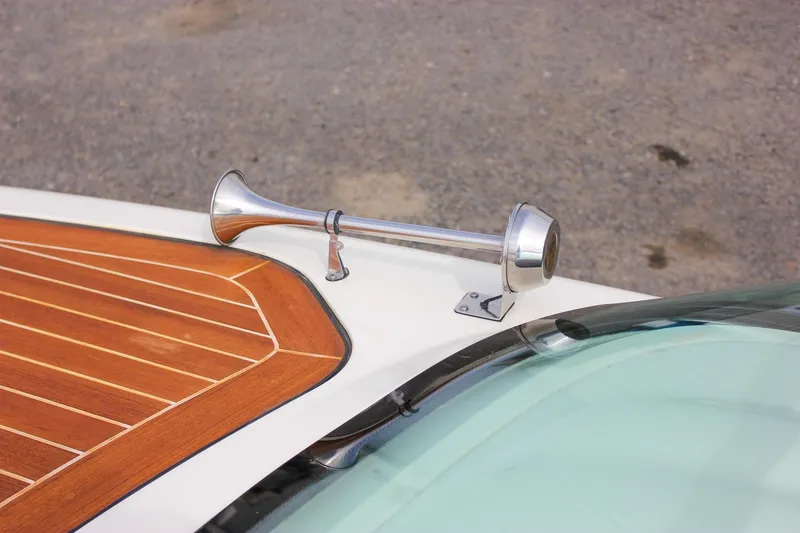 Slide: The Image of 2017 Chris-Craft Capri 27 boat with elegant wooden deck and sleek design. - 53