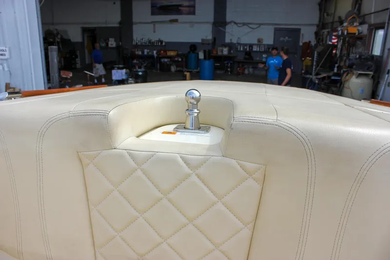 Slide: The Image of 2017 Chris-Craft Capri 27 boat with polished wooden deck, docked on gravel. - 54