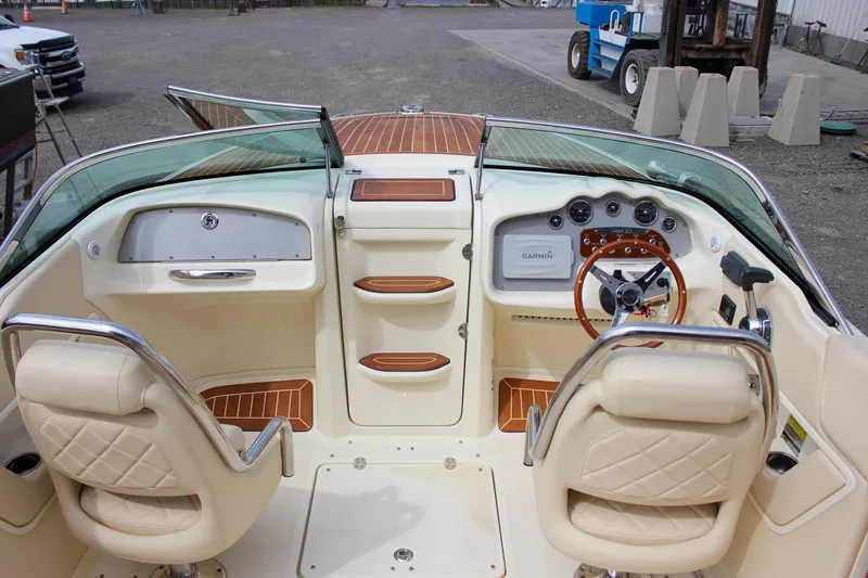 Slide: The Image of 2017 Chris-Craft Capri 27 boat with wooden deck and chrome horn detail. - 55