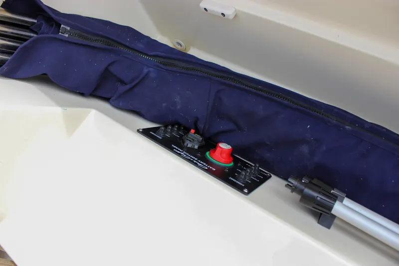 Slide: The Image of 2017 Chris-Craft Capri 27 interior with open storage compartment and luxurious seating. - 58