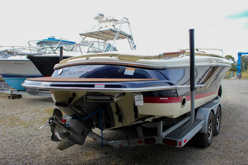 Slide: The Image of Control panel and storage area on a 2017 Chris-Craft Capri 27 boat. - 60