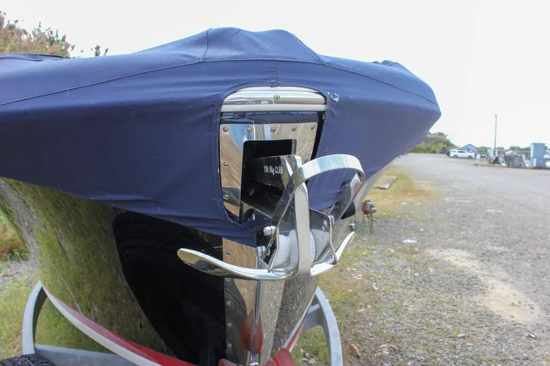 Slide: The Image of 2017 Chris-Craft Capri 27 boat on a trailer, parked on grassy terrain. - 7