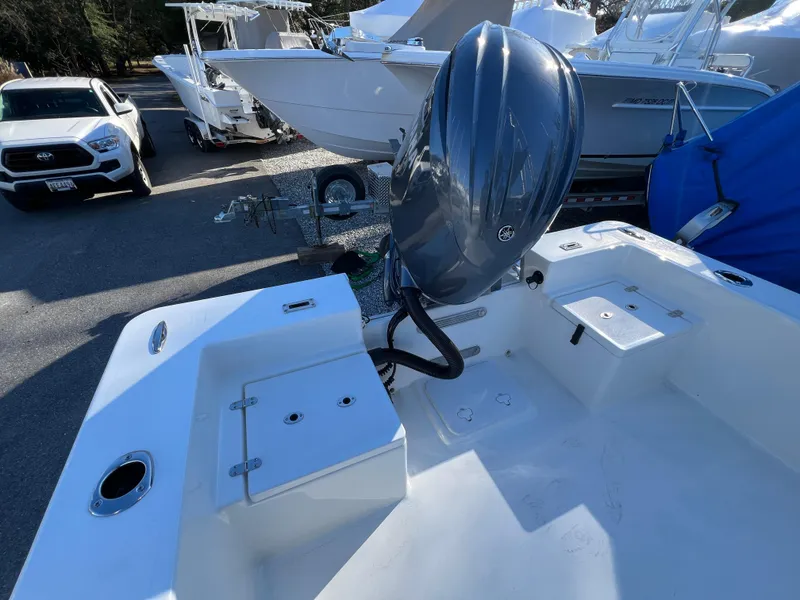 Slide: The Image of 2025 KenCraft 2260FS Bay Rider Skiff with outboard motor in a marina. - 10