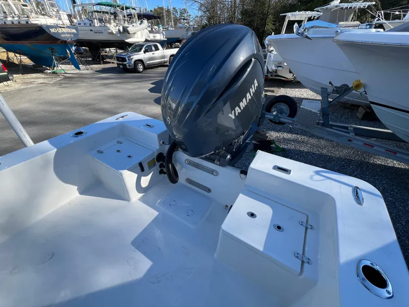 Slide: The Image of 2025 KenCraft 2260FS Bay Rider Skiff with Yamaha outboard motor in a boatyard. - 11
