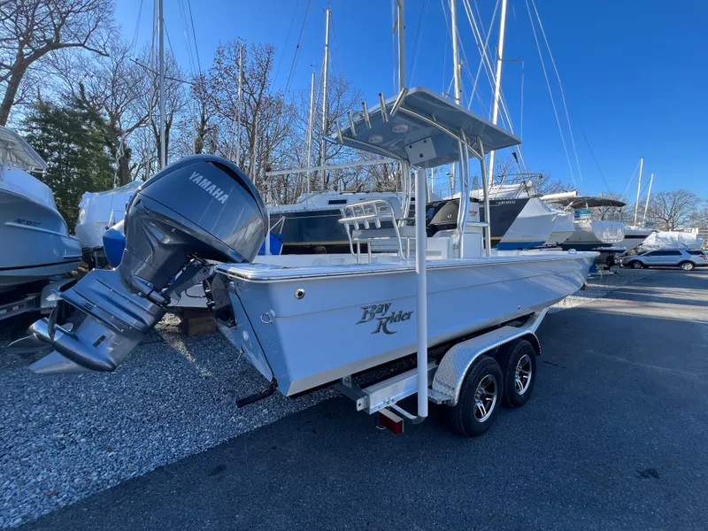 Slide: The Image of 2025 KenCraft 2260FS Bay Rider Skiff on trailer with Yamaha outboard motor. - 2