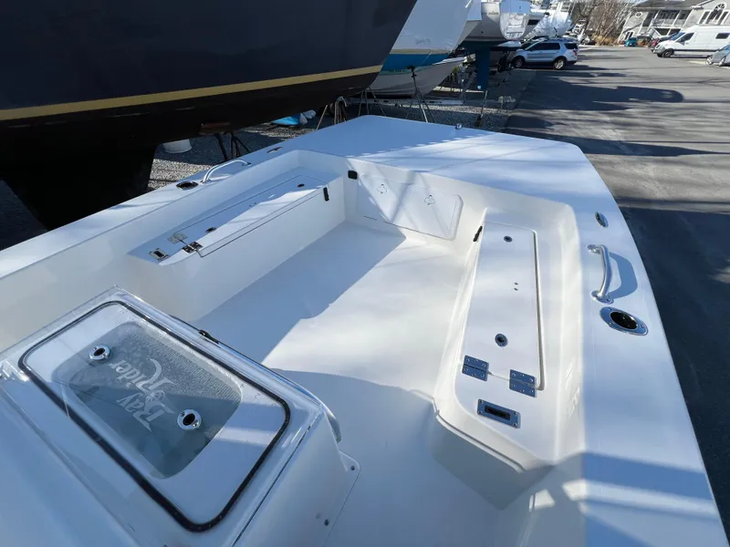 Slide: The Image of 2025 KenCraft 2260FS Bay Rider Skiff, spacious deck view in a marina. - 3