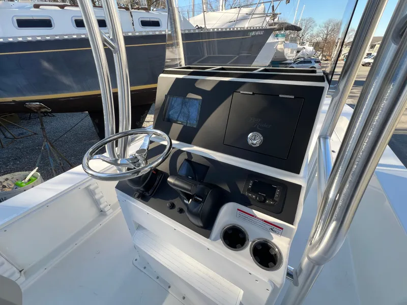 Slide: The Image of 2025 KenCraft 2260FS Bay Rider Skiff console with steering wheel and controls. - 7