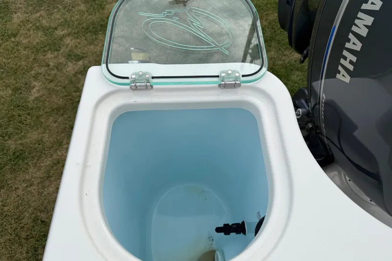Slide: The Image of Open livewell on 2019 Sailfish 275 DC boat with Yamaha engine visible. - 20