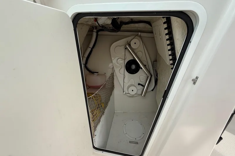 Slide: The Image of Storage compartment in 2019 Sailfish 275 DC boat, featuring organized interior and equipment. - 25