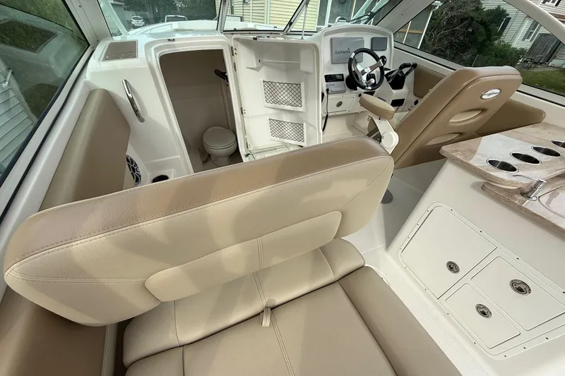 Slide: The Image of 2019 Sailfish 275 DC boat interior with helm, seating, and cabin area. - 30