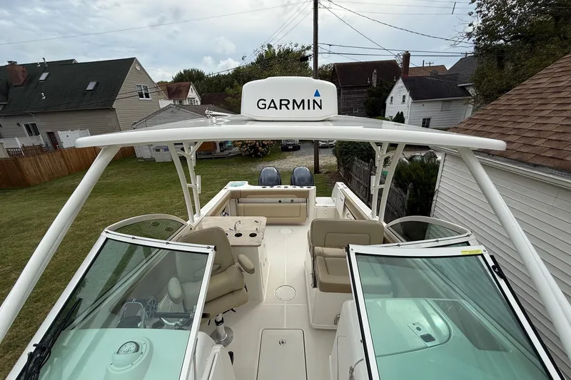 Slide: The Image of 2019 Sailfish 275 DC boat with Garmin equipment, docked near residential area. - 33