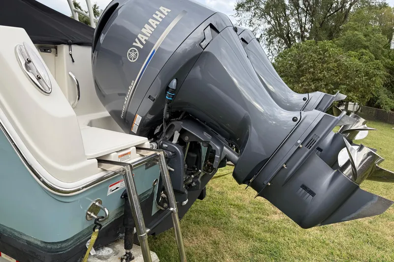 Slide: The Image of 2019 Sailfish 275 DC boat with Yamaha outboard motors on grassy area. - 9