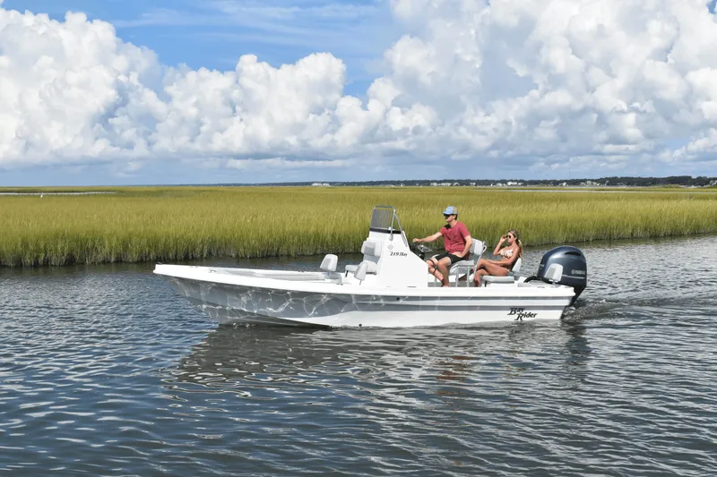 Slide: The Image of 2024 KenCraft 219 Bay Rider Bay boat cruising in a scenic waterway. - 13
