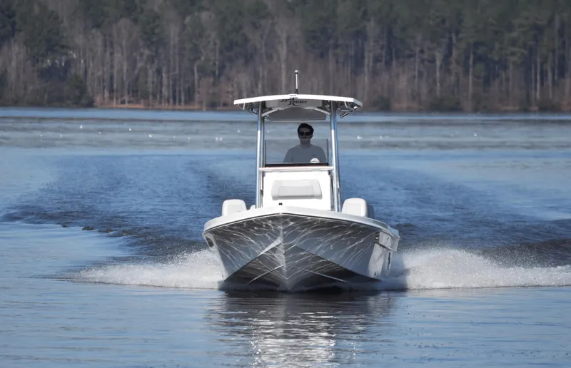 Slide: The Image of 2024 KenCraft 219 Bay Rider Bay boat cruising on a lake. - 3