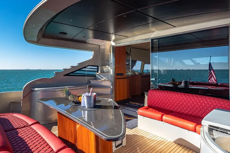 Slide: The Image of Luxurious 2008 Pershing 90 yacht interior with red seating, ocean view, and elegant design. - 15