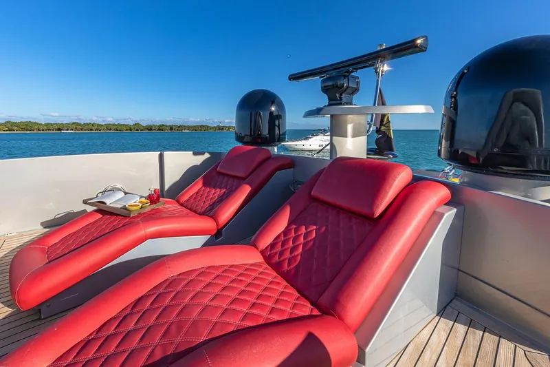 Slide: The Image of Luxurious red loungers on 2008 Pershing 90 yacht deck, overlooking serene blue waters. - 19