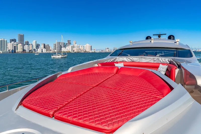 Slide: The Image of Luxury Pershing 90 yacht with red sunbed, city skyline in background, 2008 model. - 23