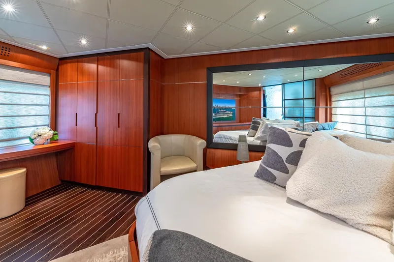 Slide: The Image of Luxurious 2008 Pershing 90 yacht bedroom with elegant wood paneling and modern decor. - 37