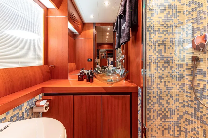 Slide: The Image of Luxurious bathroom on 2008 Pershing 90 yacht with wood accents and mosaic tiles. - 40