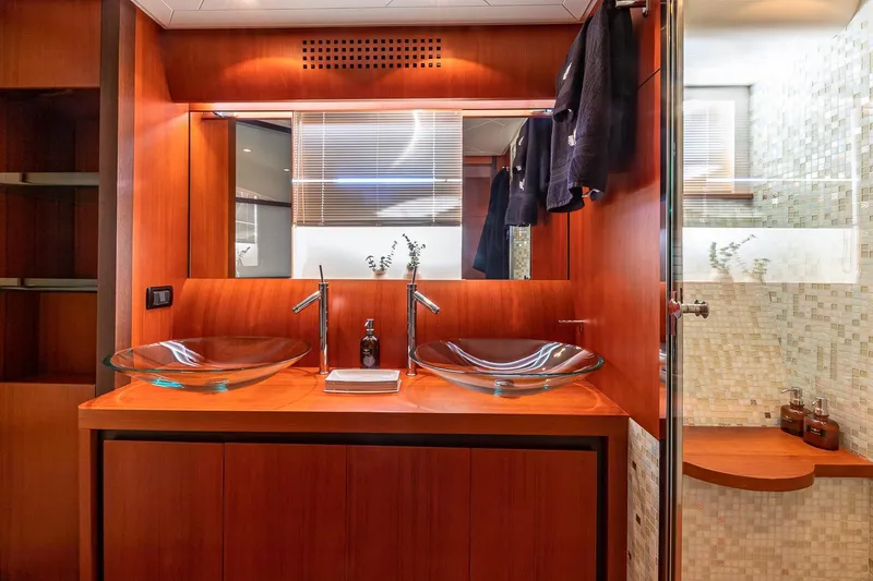 Slide: The Image of Luxurious bathroom interior on 2008 Pershing 90 yacht with dual glass sinks and wooden accents. - 42