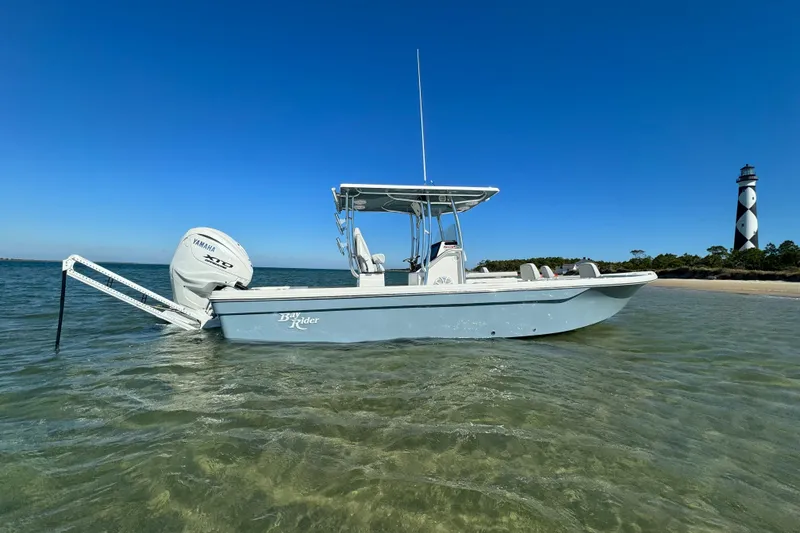 Slide: The Image of 2025 KenCraft 269 Bay boat anchored near a lighthouse in shallow water. - 8