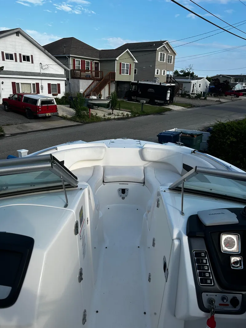 Slide: The Image of 2008 Chaparral Sunesta 244 boat docked in a residential neighborhood. - 19