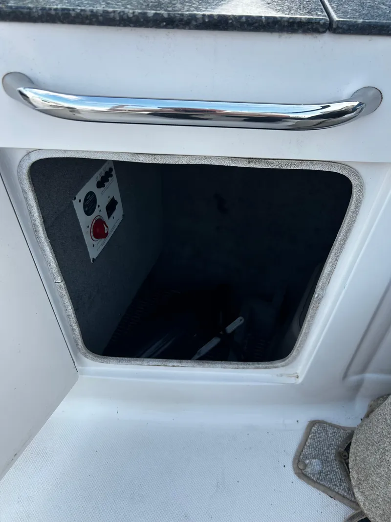 Slide: The Image of Storage compartment in 2008 Chaparral Sunesta 244 boat with control panel inside. - 22