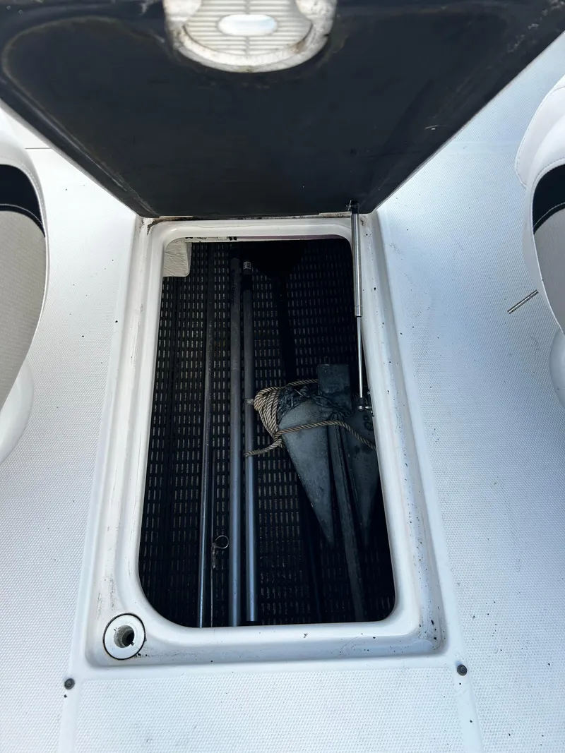 Slide: The Image of 2008 Chaparral Sunesta 244 storage compartment with open hatch, showing interior details. - 23