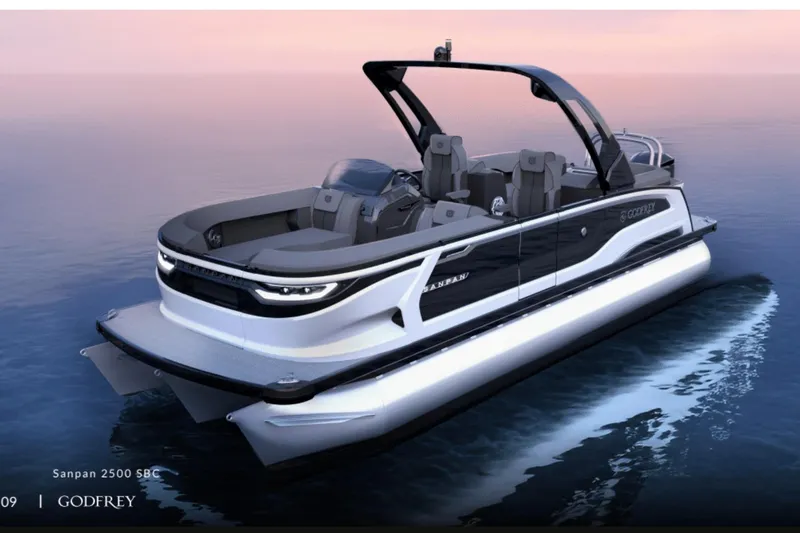 Slide: The Image of 2026 Godfrey Sanpan 27' Tritoon on serene water at sunset, showcasing sleek design. - 1