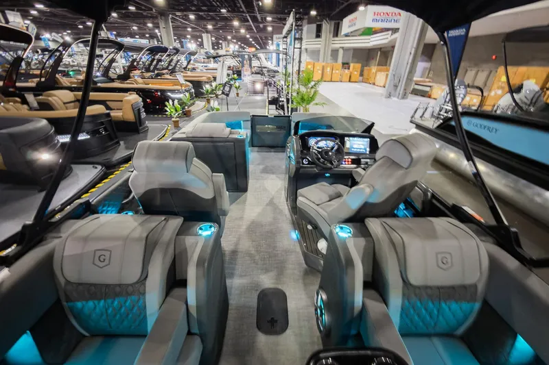 Slide: The Image of Luxurious 2026 Godfrey Sanpan 23' Split Bench pontoon boat interior at a boat show. - 31