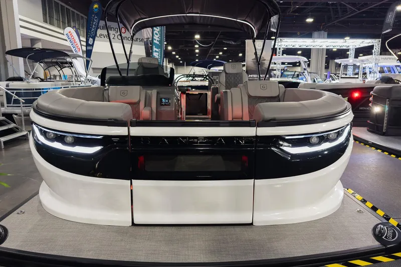 Slide: The Image of 2026 Godfrey Sanpan 23' Split Bench pontoon boat displayed at an indoor boat show. - 8