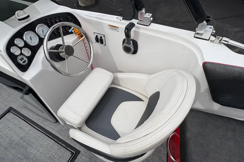 Slide: The Image of Cockpit of 2017 Razor 238 PF XL boat with steering wheel and gauges. - 10