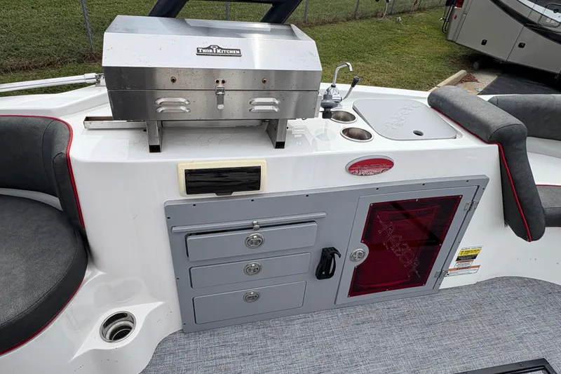 Slide: The Image of 2017 Razor 238 PF XL boat with grill, sink, and storage compartments. - 11