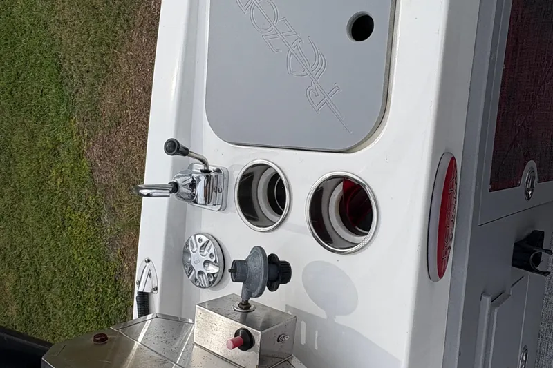 Slide: The Image of 2017 Razor 238 PF XL boat dashboard with controls and cup holders. - 12