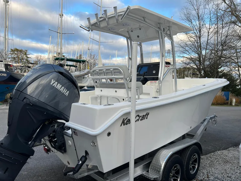 Slide: The Image of 2024 KenCraft 21 boat with Yamaha engine on trailer, docked at marina. - 2