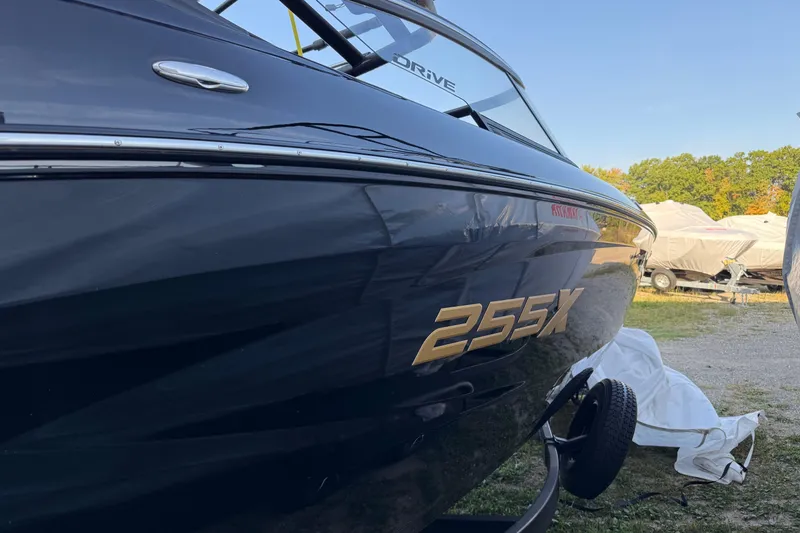 Slide: The Image of 2026 Yamaha Boats 255XD, sleek black exterior, parked outdoors. - 3