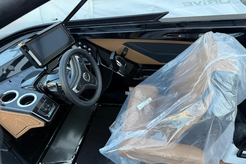 Slide: The Image of 2026 Yamaha Boats 255XD cockpit with steering wheel, touchscreen, and covered seat. - 7