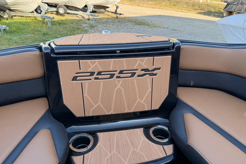 Slide: The Image of 2026 Yamaha Boats 255XD interior with stylish seating and cup holders. - 8