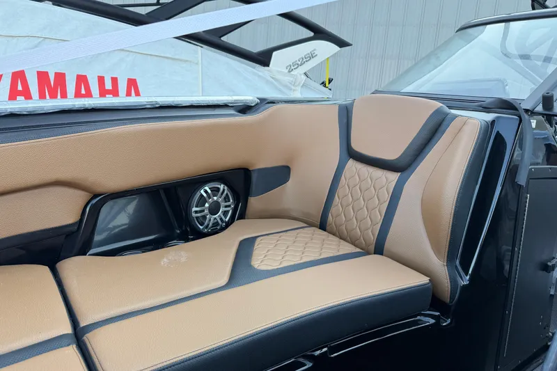 Slide: The Image of 2026 Yamaha Boats 255XD interior with tan and black seating, featuring a built-in speaker. - 9
