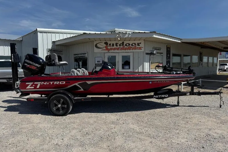 Slide: The Image of 2013 Nitro Z7 SC boat in red, parked outside Outdoor Specialties building. - 7