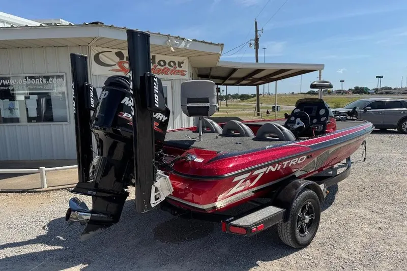 Slide: The Image of 2013 Nitro Z7 SC boat in red, parked outdoors near a building. - 9