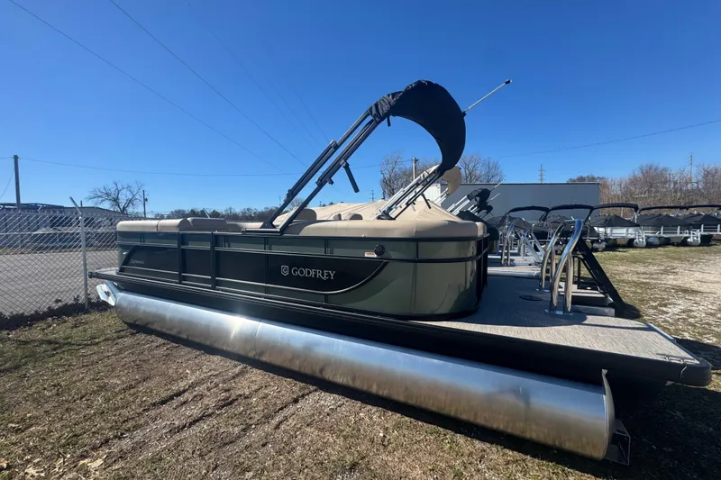 Slide: The Image of 2026 Godfrey Xperience 2286 SBX pontoon boat displayed outdoors on a sunny day. - 12
