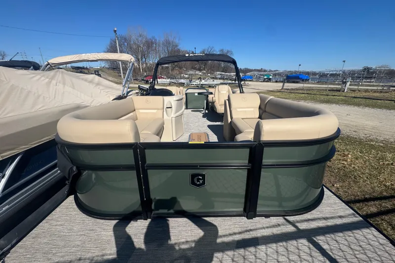 Slide: The Image of 2026 Godfrey Xperience 2286 SBX pontoon boat with beige seating, docked outdoors. - 14