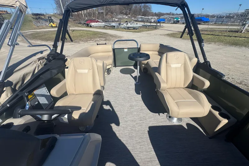 Slide: The Image of 2026 Godfrey Xperience 2286 SBX pontoon boat interior with beige seating and table. - 18