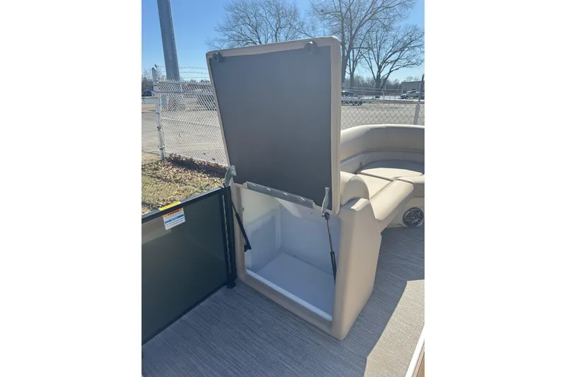 Slide: The Image of 2026 Godfrey Xperience 2286 SBX boat storage compartment with open seat and beige interior. - 21