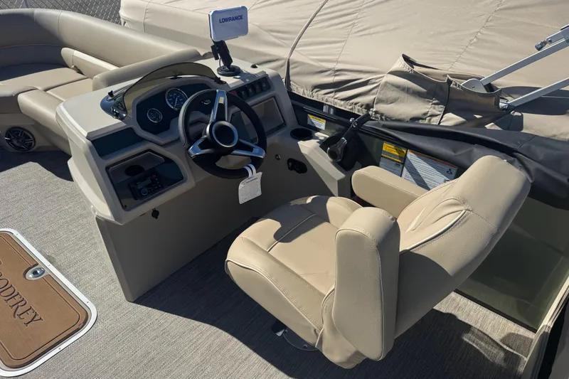 Slide: The Image of Interior of 2026 Godfrey Xperience 2286 SBX boat with steering wheel and beige seating. - 22
